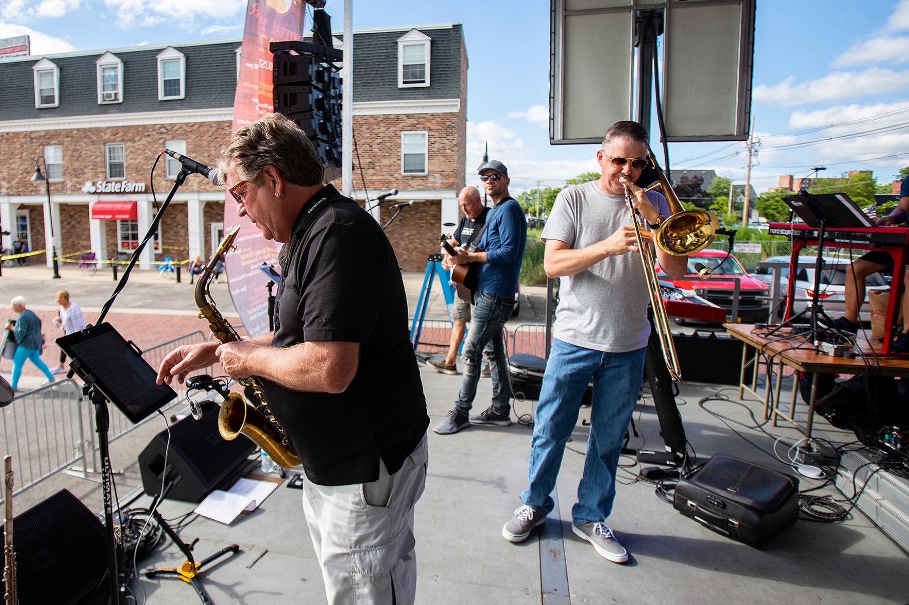 Zoom image: Band members go through a sound check in the late afternoon as they prepare to perform at Tonawanda's Gateway Harbor for the Wednesday Night Canal Concert Series. Barry Arbogast (left) plays the saxophone. 