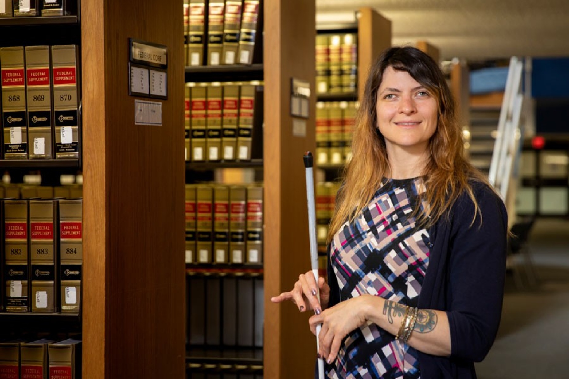 Maura Kutnyak standing in UB's Law Library. 