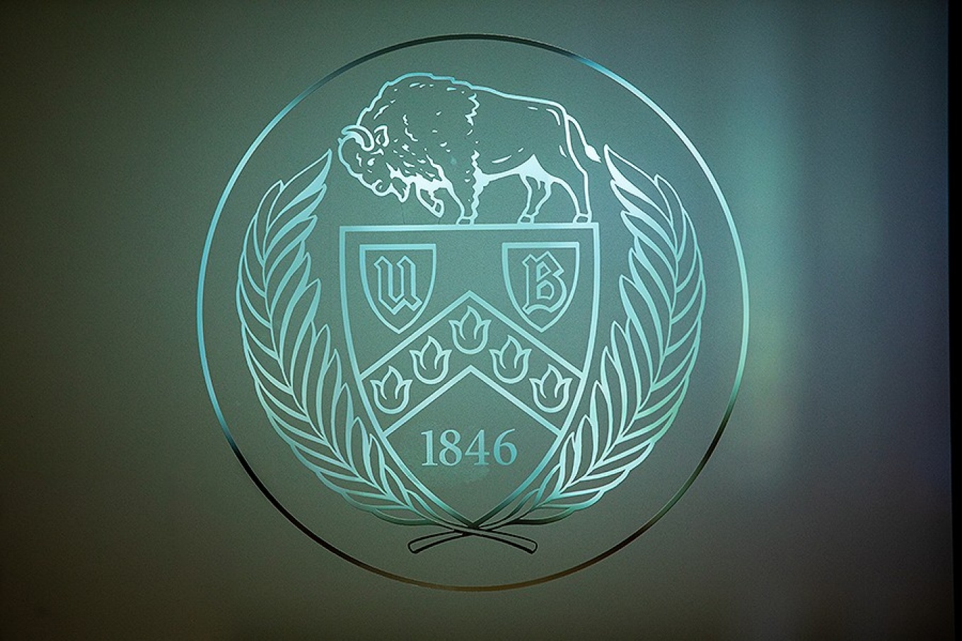 Zoom image: The UB seal on frosted glass greets visitors as they enter the University Club. Photo: Douglas Levere 