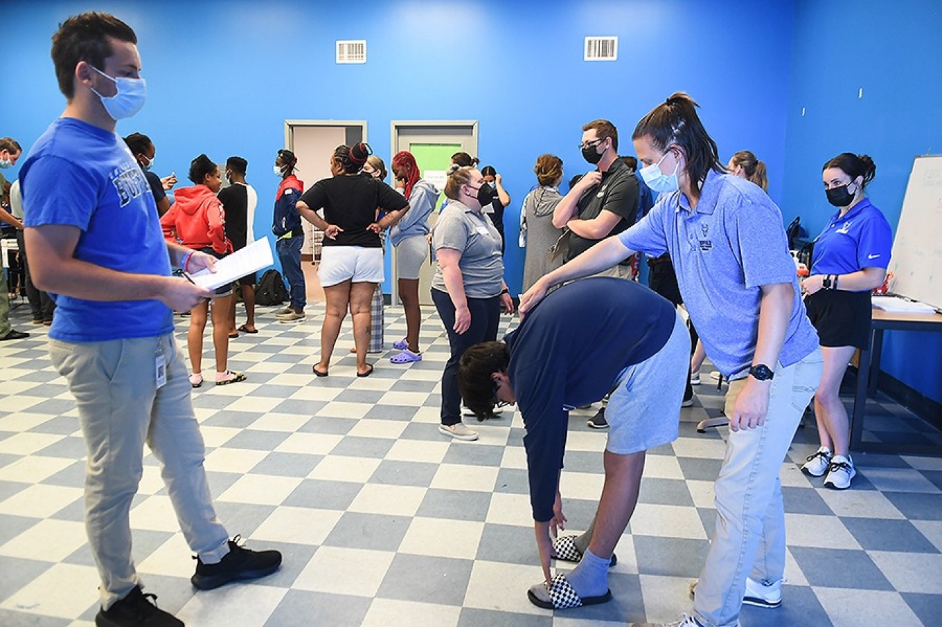 A student being checked for scoliosis and musculoskeletal system agility by Caleb Hancock, in year two of UB Masters Athletic Training. 