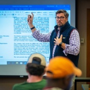 Matthew Pelkey in classroom with students. 