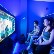 Students playing Mortal Kombat in the Level Up space. 