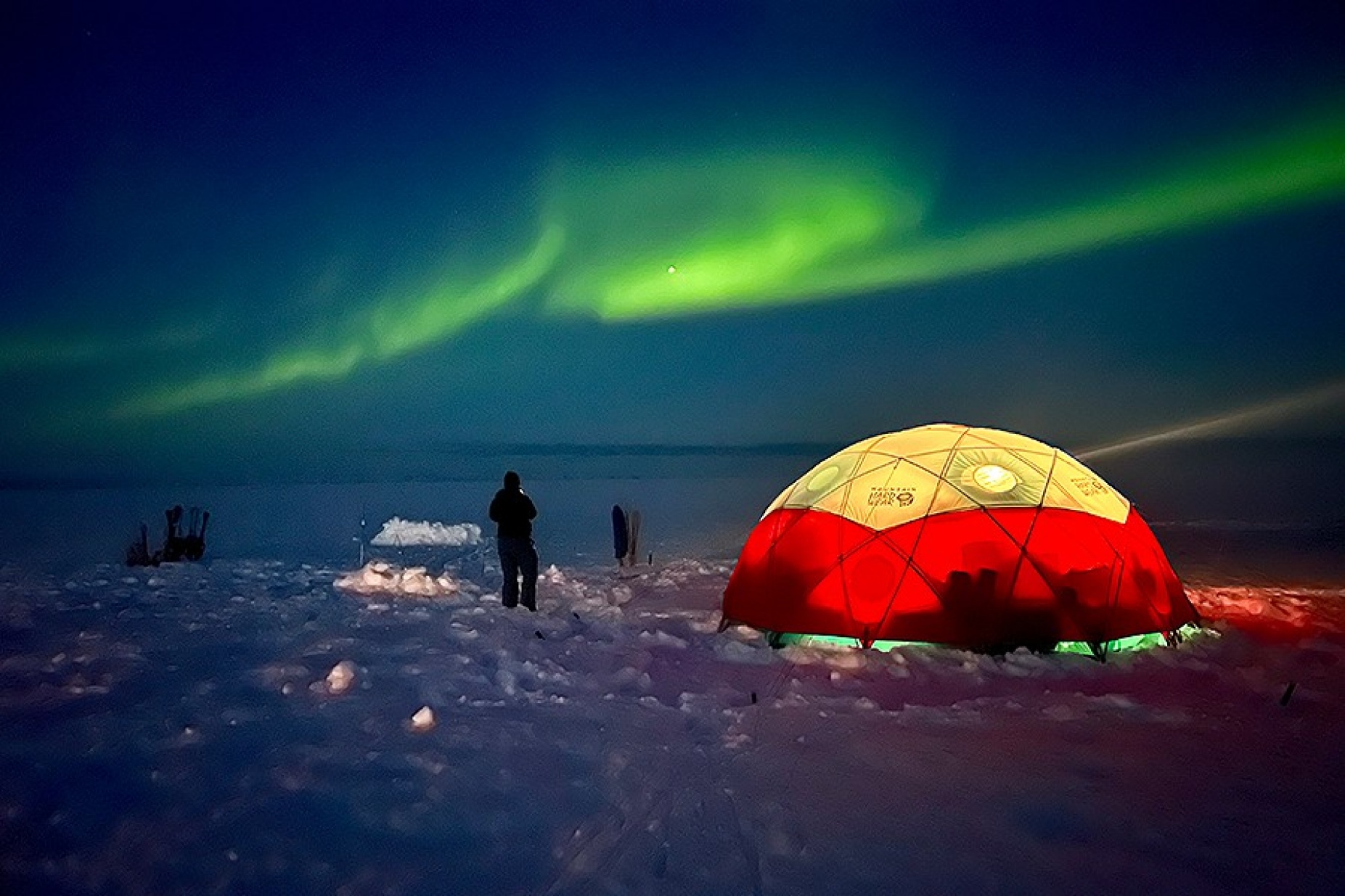Northern lights over a camp site. 