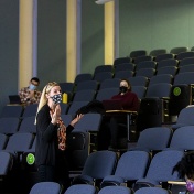 Sarahmona Przybyla teaching a class in an auditorium. 