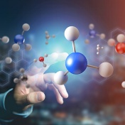 A hand reaching towads a 3D model of molecules. 