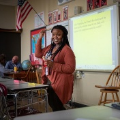 Teacher resident working with student at a desk. 