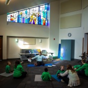 Zoom image: Vito Gigante, director of occupational therapy at the Beyond Learning Center (formerly the Cantalician Center for Learning) leads young children in a yoga practice. Photos: Douglas Levere 