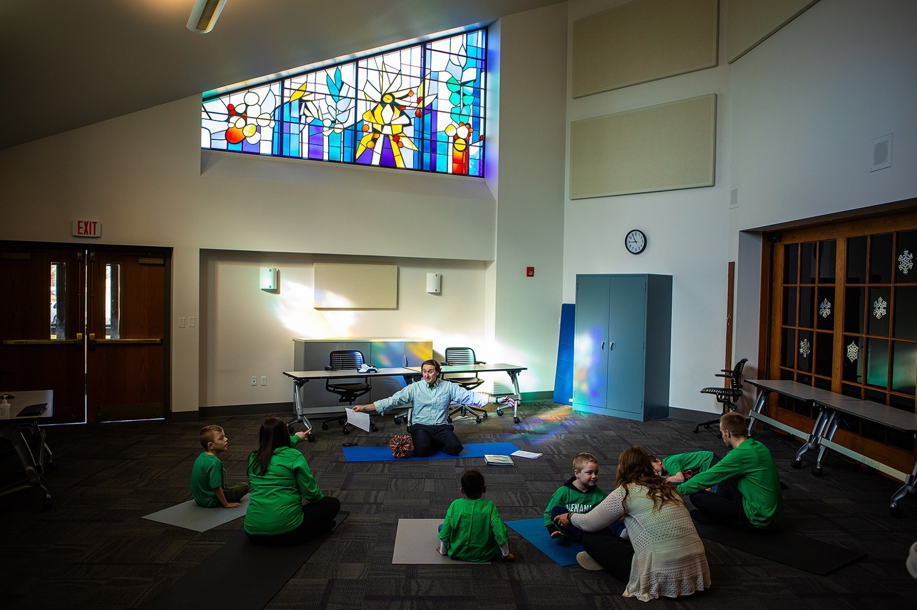 Zoom image: Vito Gigante, director of occupational therapy at the Beyond Learning Center (formerly the Cantalician Center for Learning) leads young children in a yoga practice. Photos: Douglas Levere 