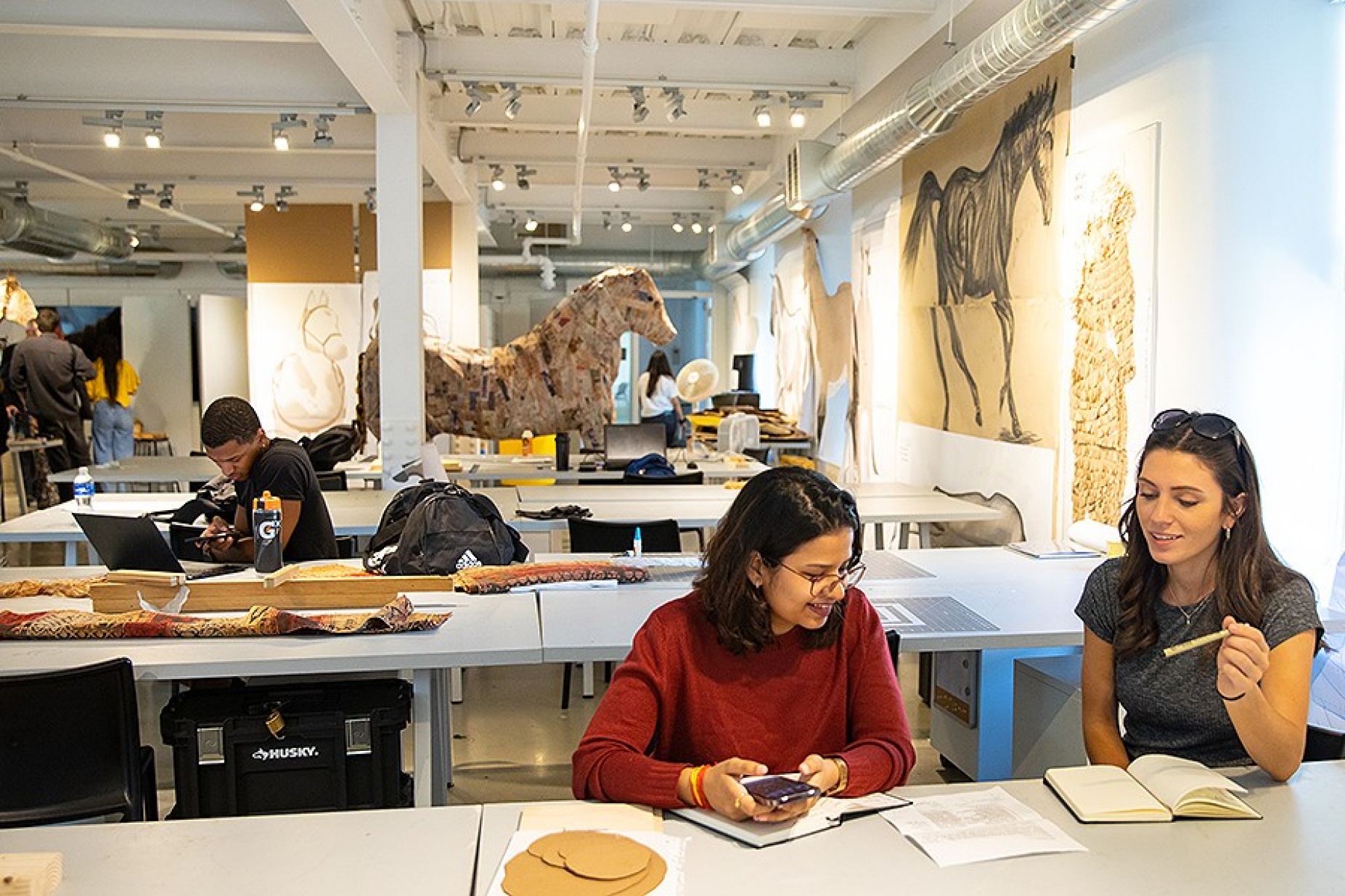 Zoom image: Students work in the HORSE Studio in Hayes Hall. The horse model in the background is one of several built by the students. Photo: Meredith Forrest Kulwicki 