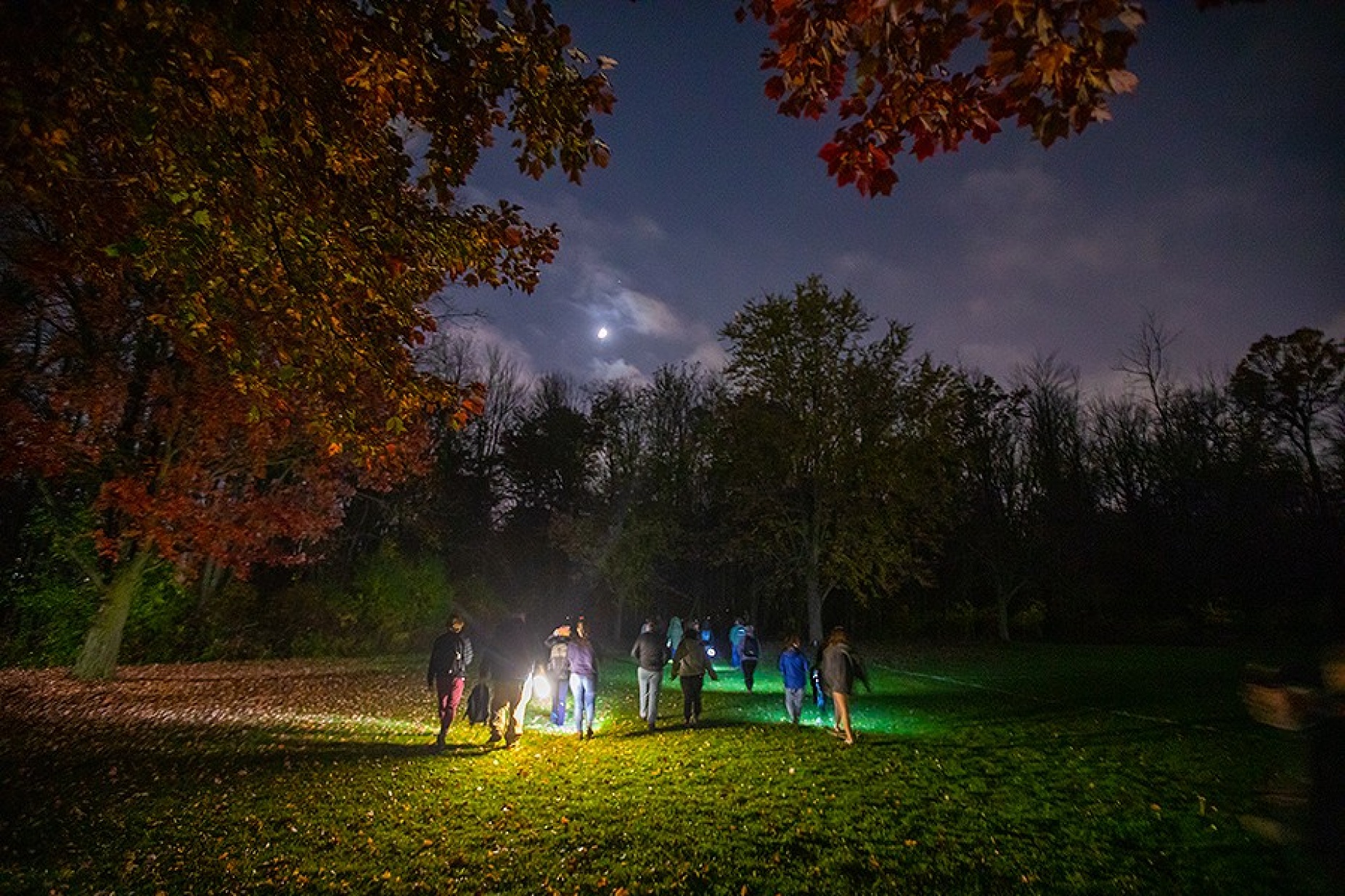 Zoom image: Students head into the Letchworth Teaching Forest for a wilderness first aid course led by Russ Crispell. The class was held after nightfall, which provides a more realistic scenario for practicing these skills. Photo: Douglas Levere 