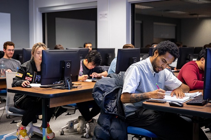 A class of students using computers. 