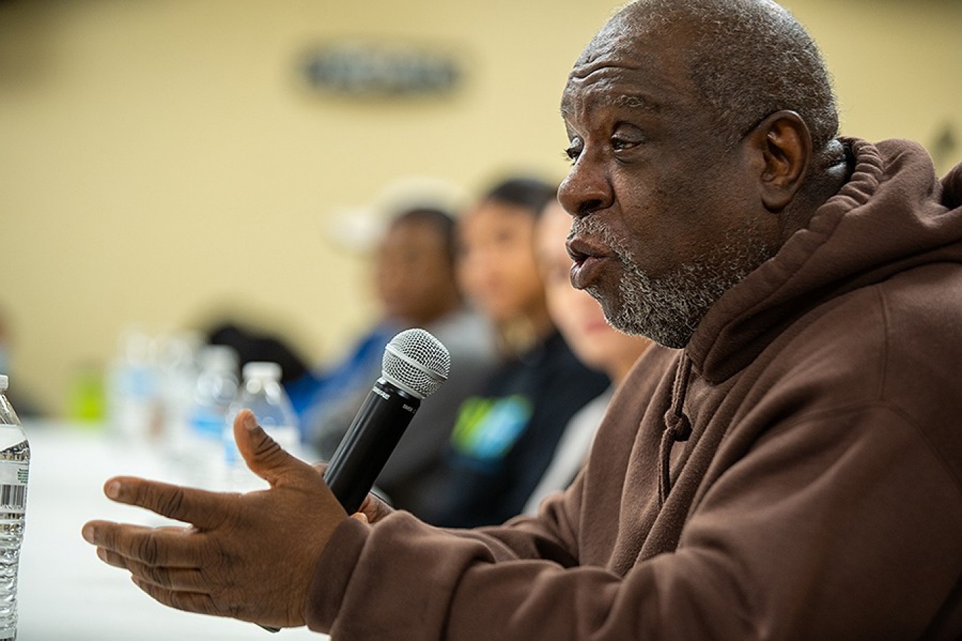 Community member, Zanny Harper, speaks during a community twon hall event. 