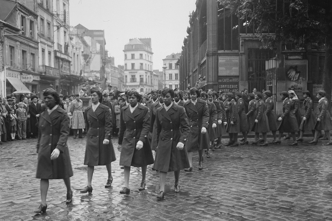 Members of the 6888th Central Postal Directory Battalion take part in a parade ceremony in honor of Joan d'Arc at the marketplace where she was burned at the stake., May 27, 1945. 