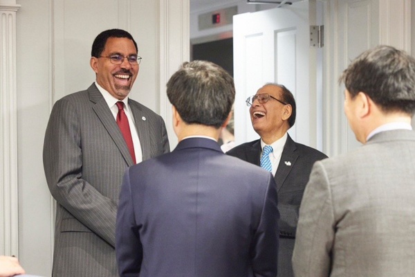 Chancellor King, President Tripathi and two others share a laugh. 