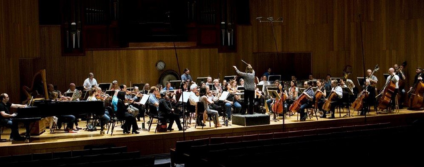 Zoom image: Members of the Buffalo Philharmonic Orchestra prepare for their 2018 June in Buffalo performance. The BPO will open this year's festival on June 6. Photo: Irene Haupt 