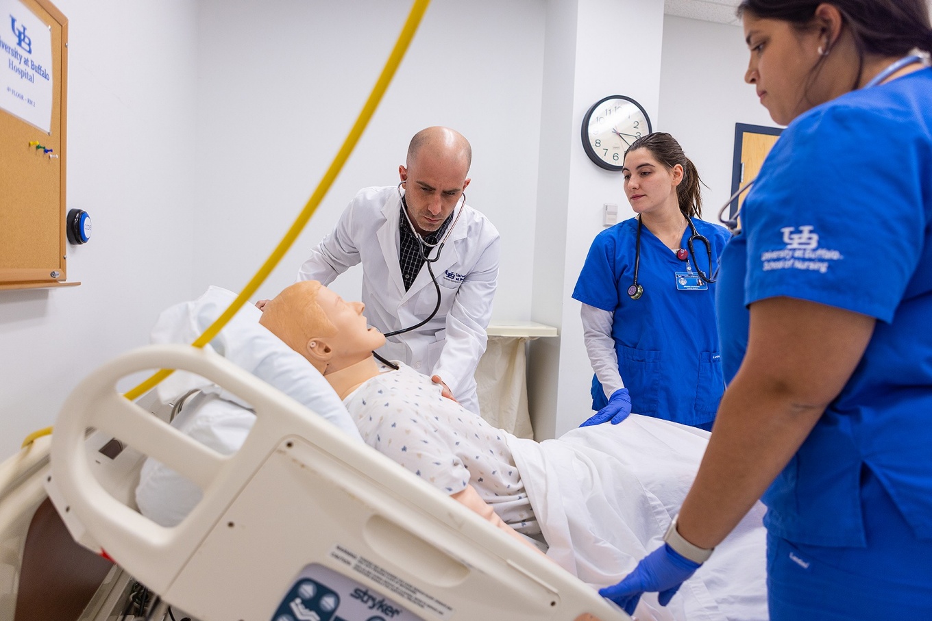 Nurses practicing patient care simulation. 