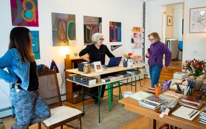 Three people in a bookstore setting. 