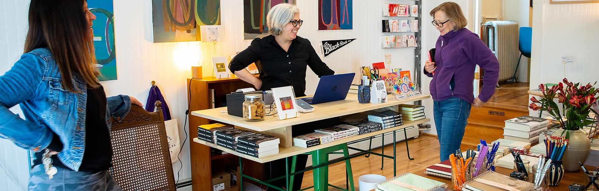 Three people in a bookstore setting. 