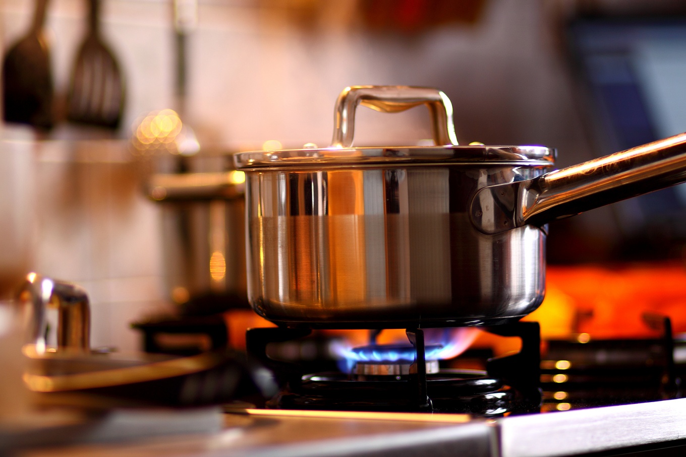 A cooking pot on a gas stove-top. 