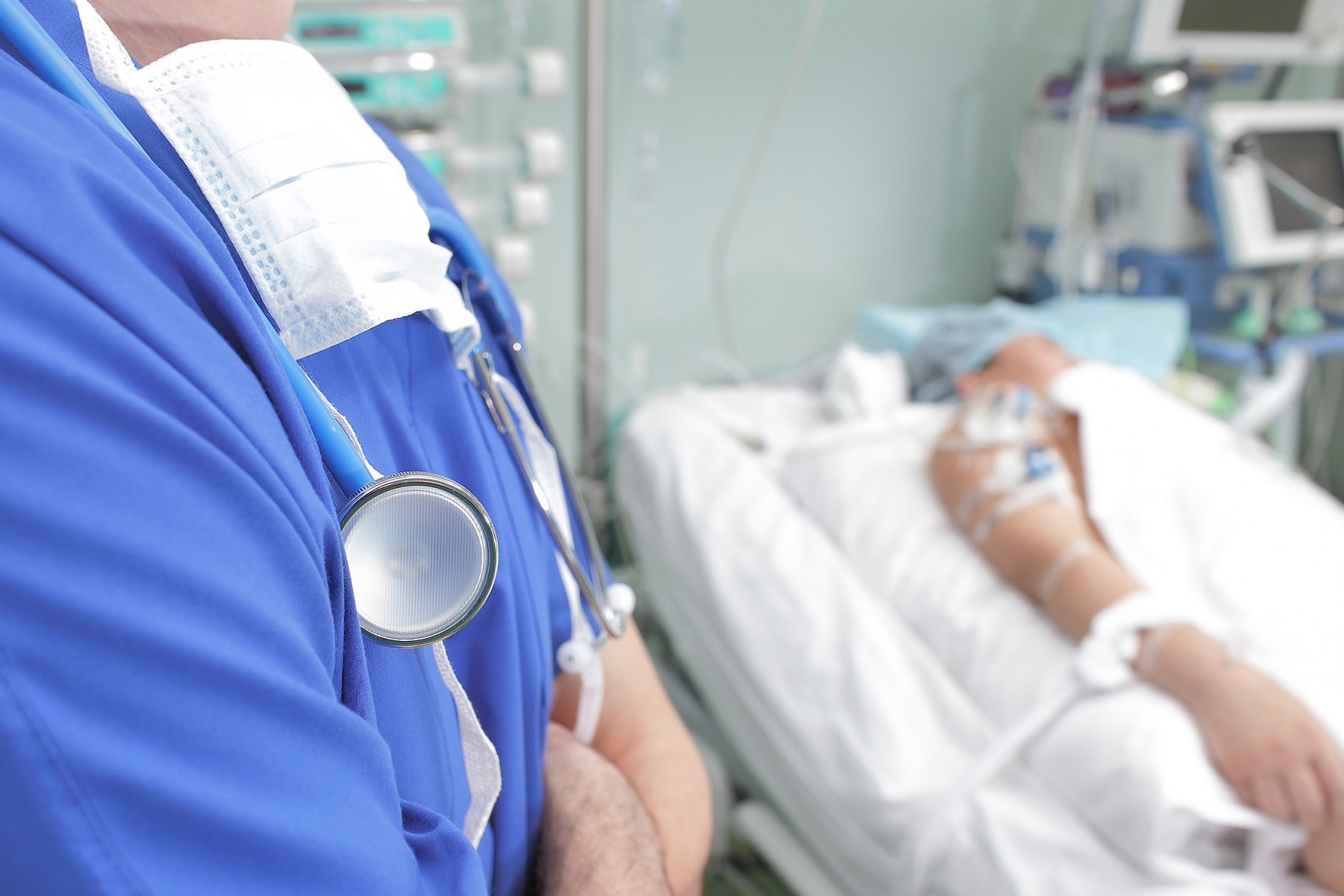 A surgeon checks on a patient following surgery. 