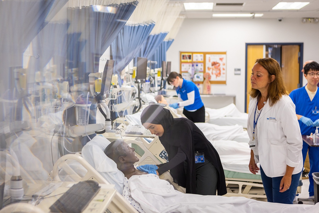 Nursing students working in a simulation lab. 
