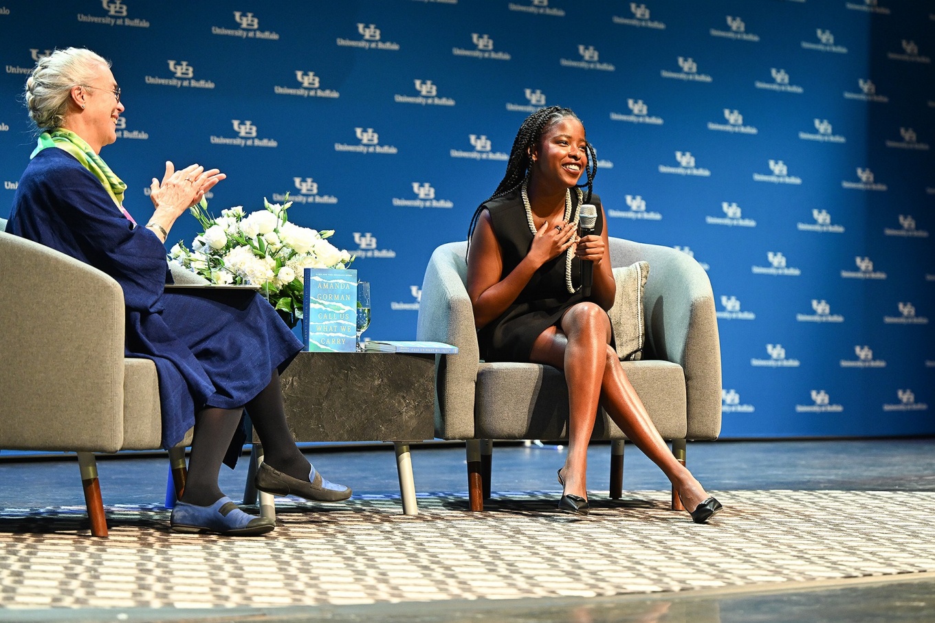Amanda Gorman, sitting on stage with moderator Cristanne Miller during her Distinguished Speakers Series visit. 