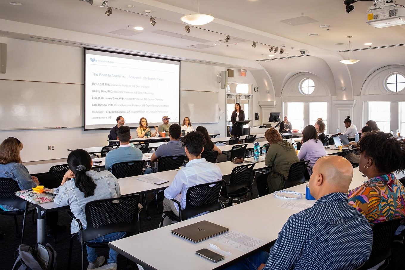 A panel discussion taking place with an attentive audience. 