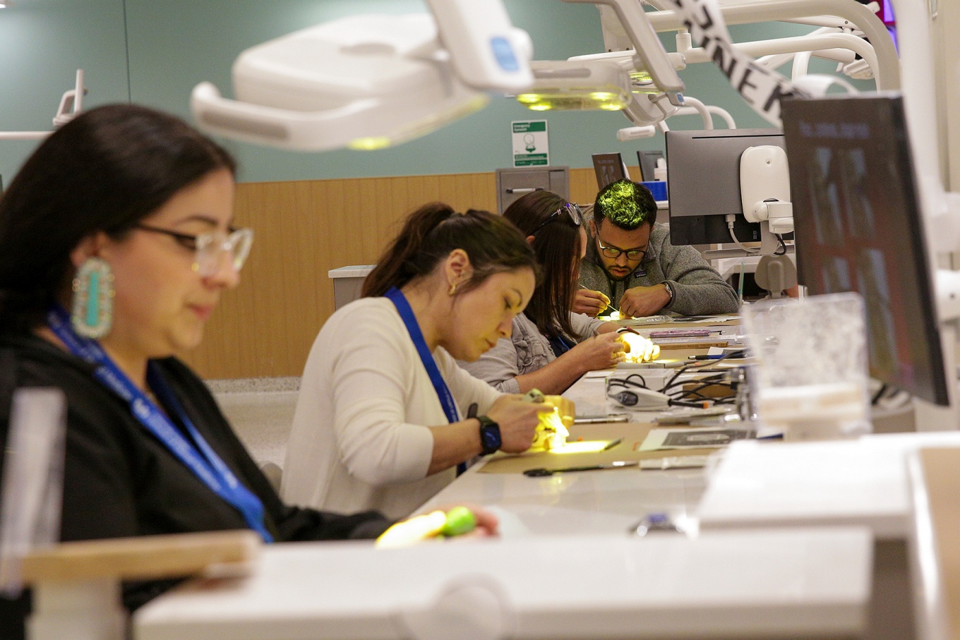 Four students in the lab taking part in hands-on work.