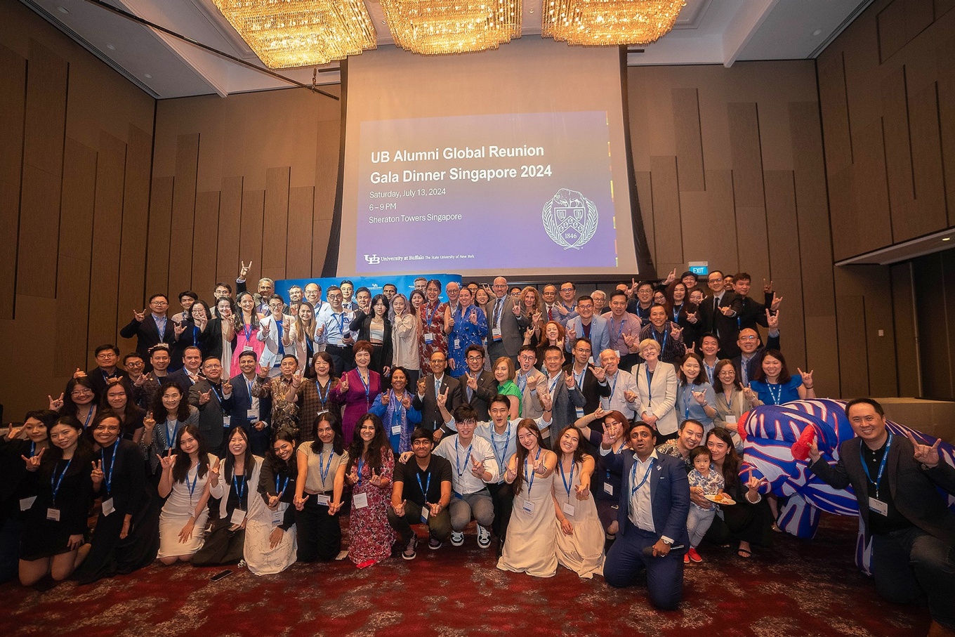 Large group of people posing together during the Global Reunion Gala. 