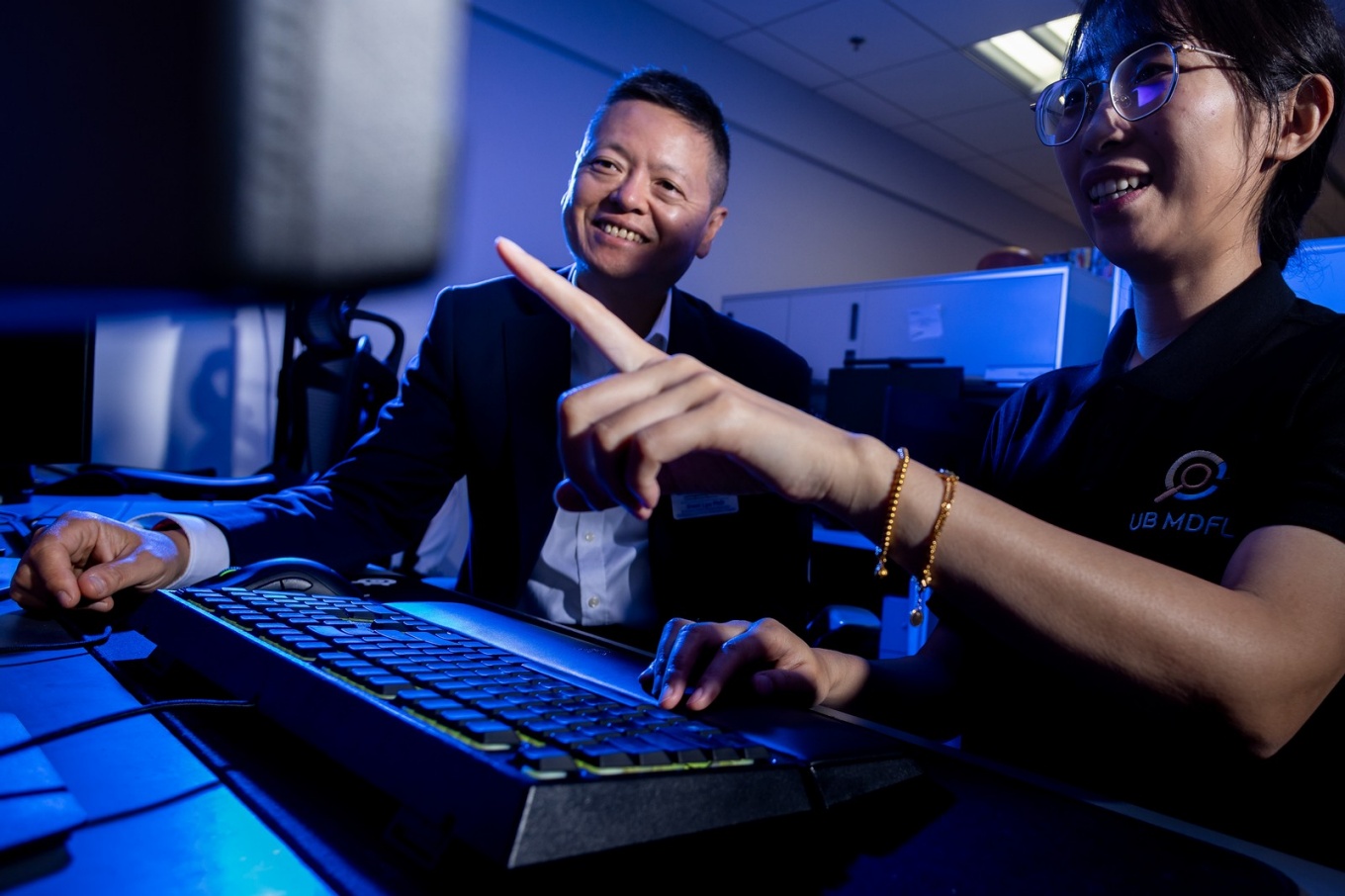 Siwei Lyu, a media forensics expert with the department of computer science and engineering, works with the members of his lab in Davis Hall in August 2024. \r\rPhotographer: Meredith Forrest Kulwicki. 