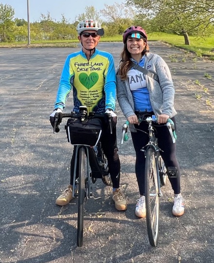Two people posing together astride bikes. 