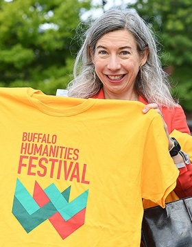 Libby otto holding a Buffalo Humanities Festival T-shirt. 