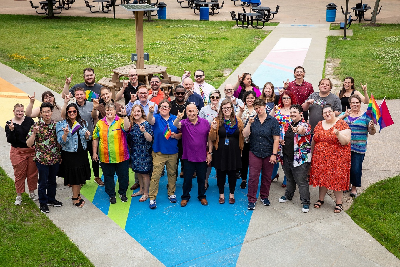 Members of the LGBTQ Faculty Staff Association pose together on the Pride Path. 