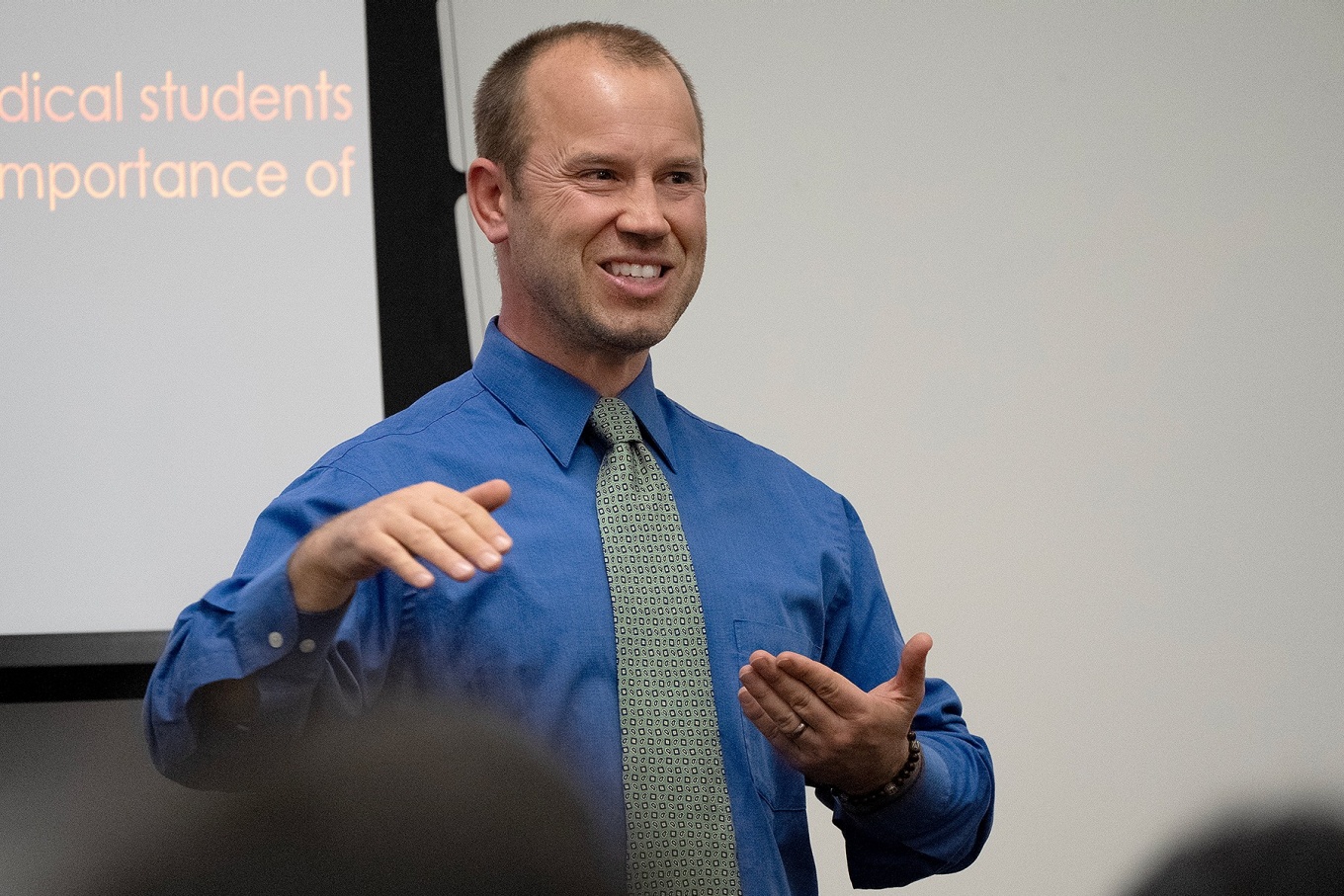 Shawn Vainio speaking with the audience during 2024 Global Health Grand Rounds. 