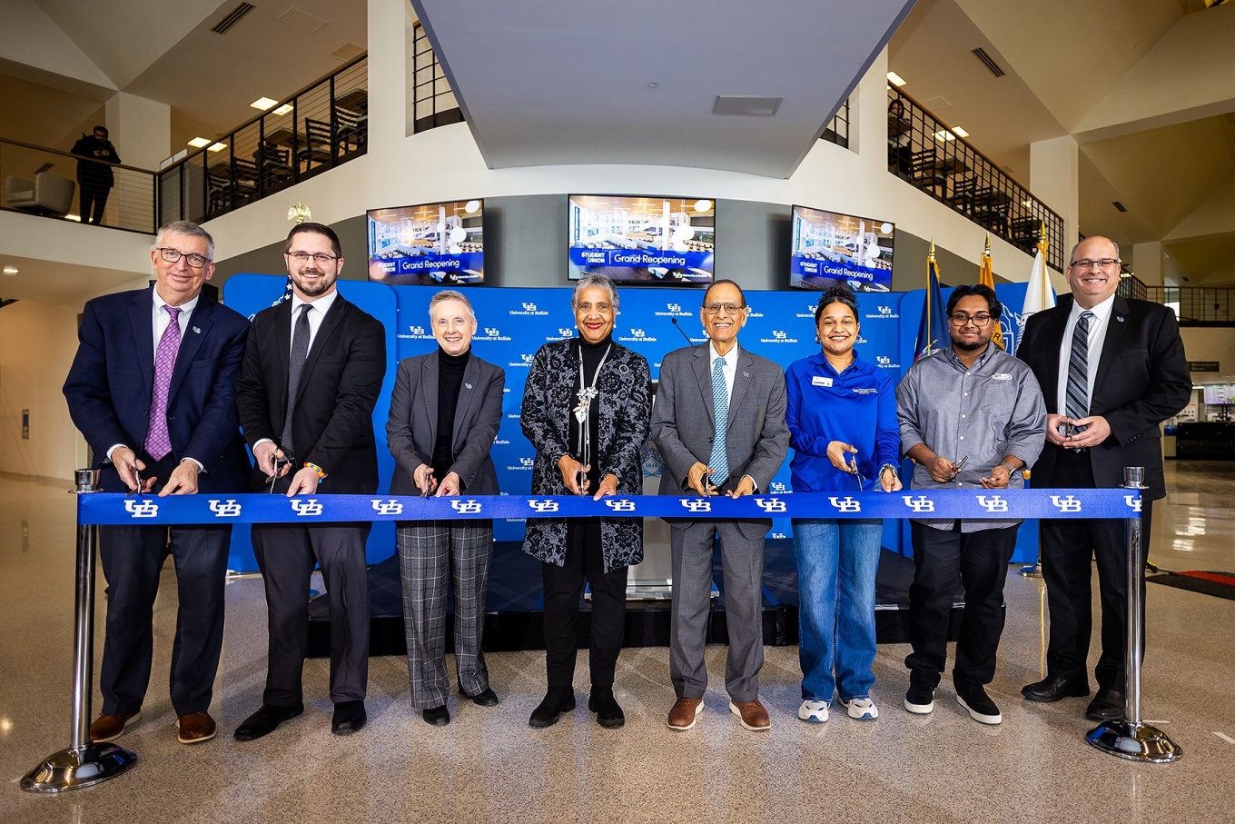 Members of UB Administration and VIPs cut the ribbon at the North Campus Student Union reopening ceremony. 
