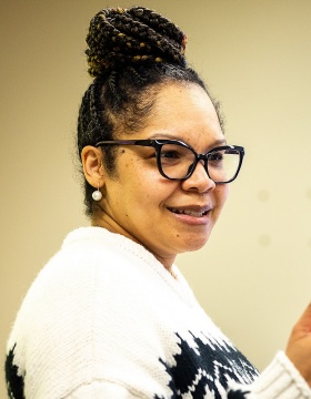 Christina King teaches a class while Dawnavyn James listens in the background. 