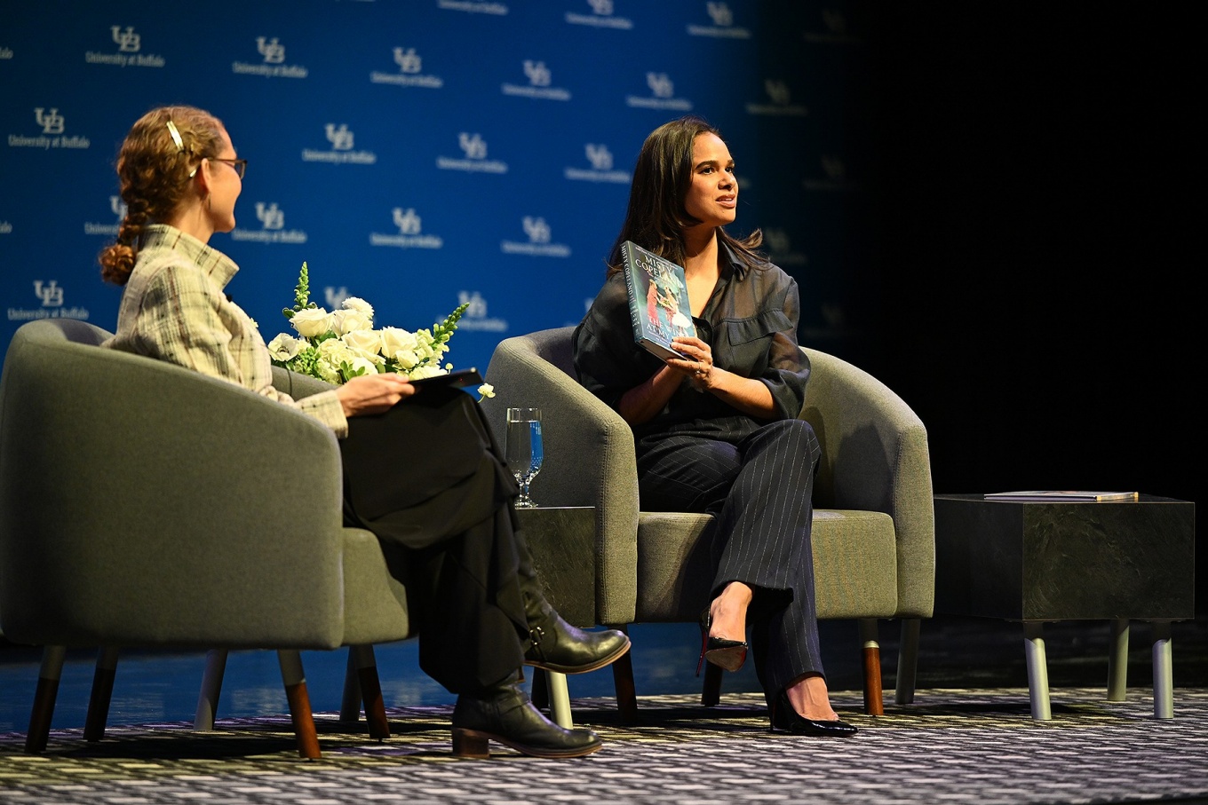 Misty Copeland holds up a book during her appearance. 