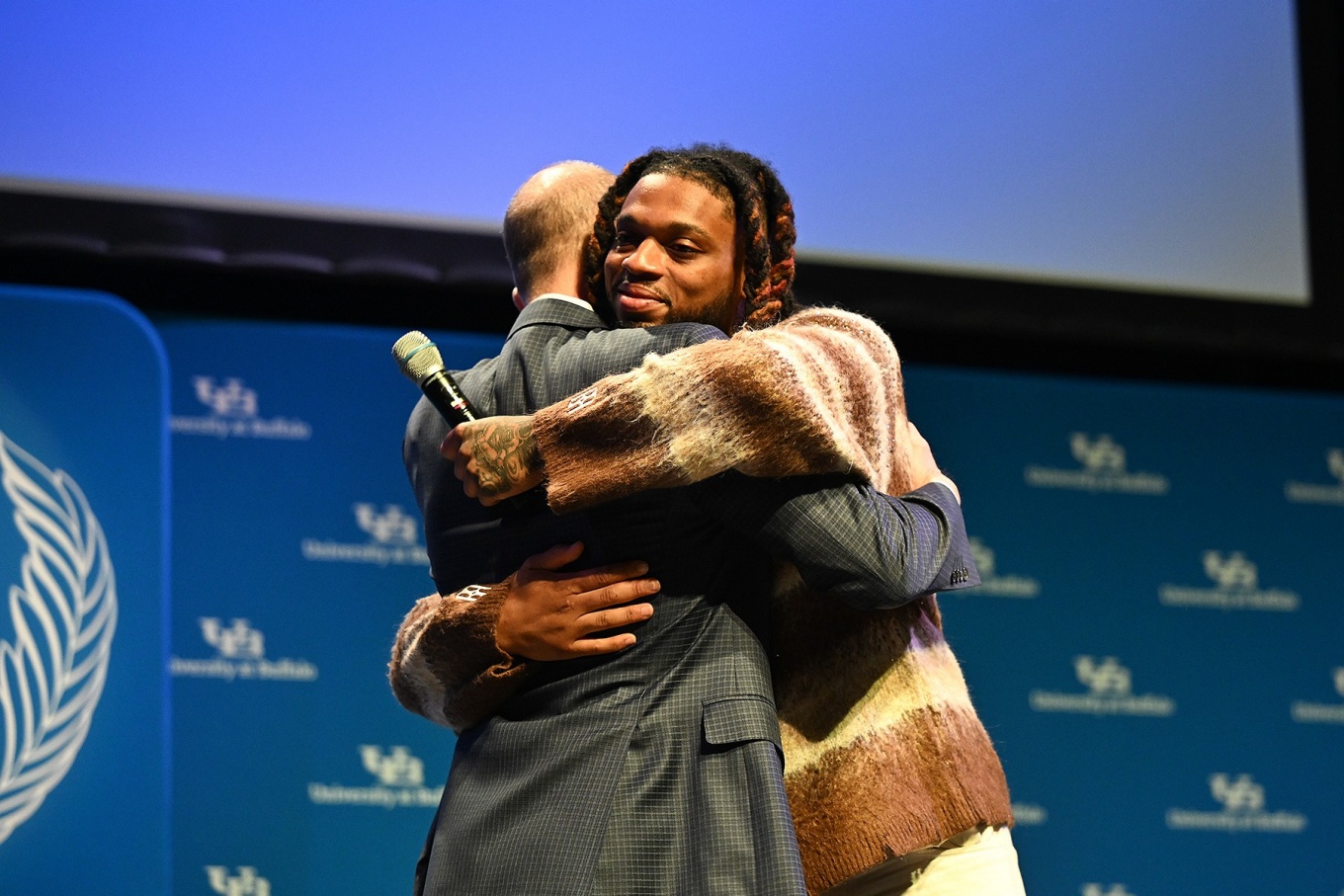 Damar Hamlin hugs Leslie Bisson who was one of the doctors who cared for Hamlin and served as moderator for the discussion. Photo: Nancy J. Parisi. 