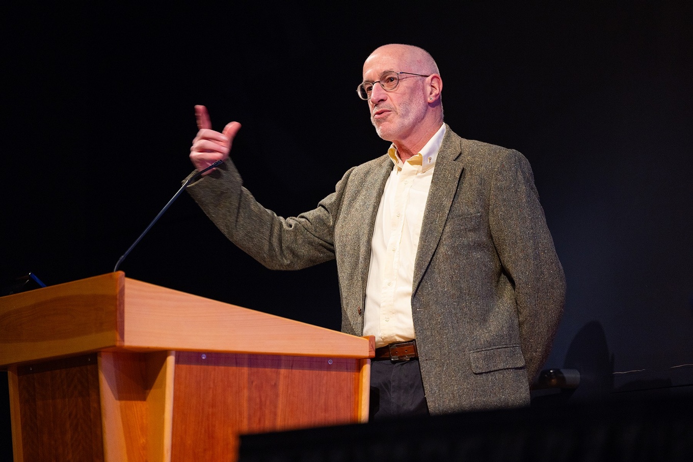 E. Bruce Pittman speaking from a podium. 