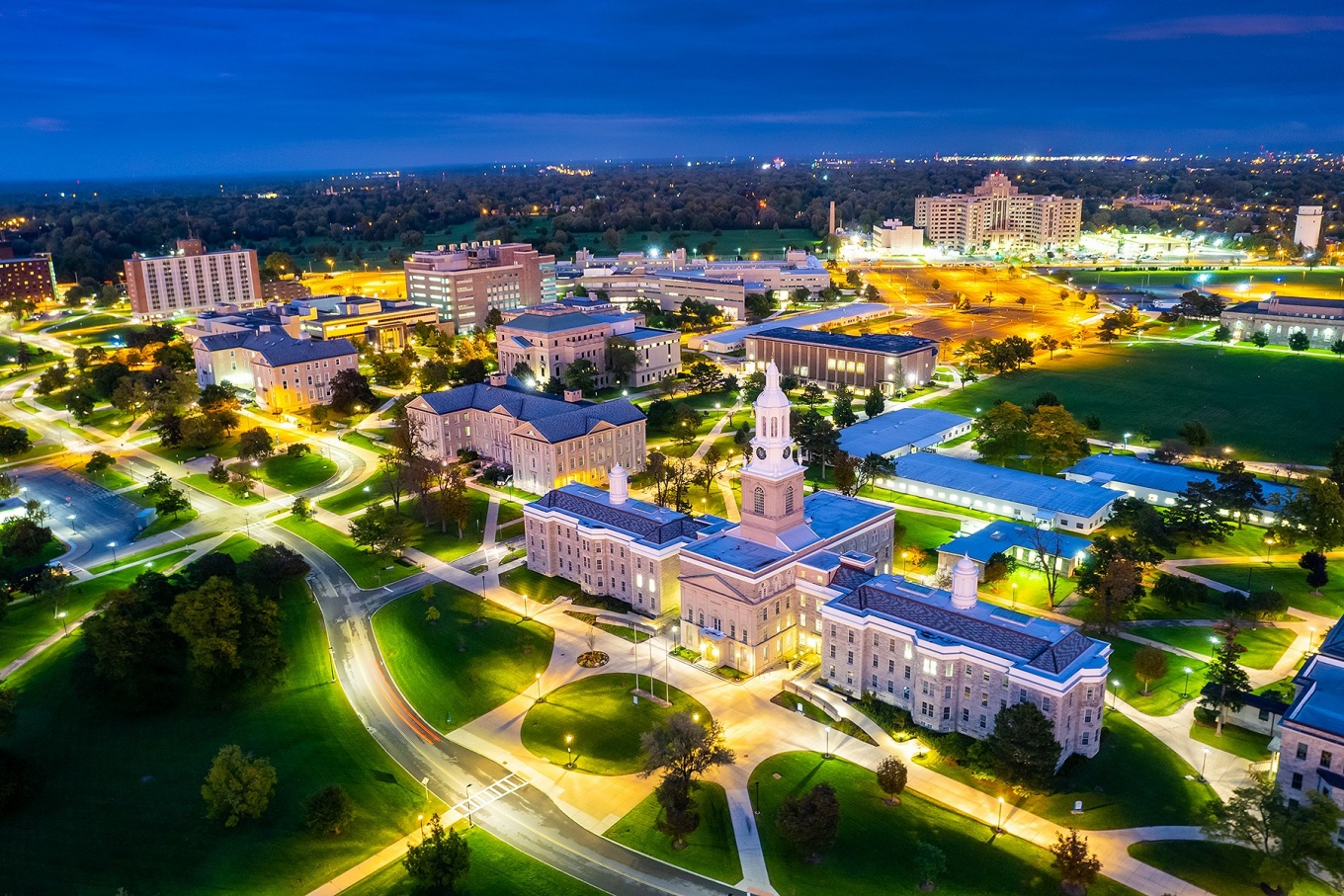Aerial view of South Campus lit up at night. 