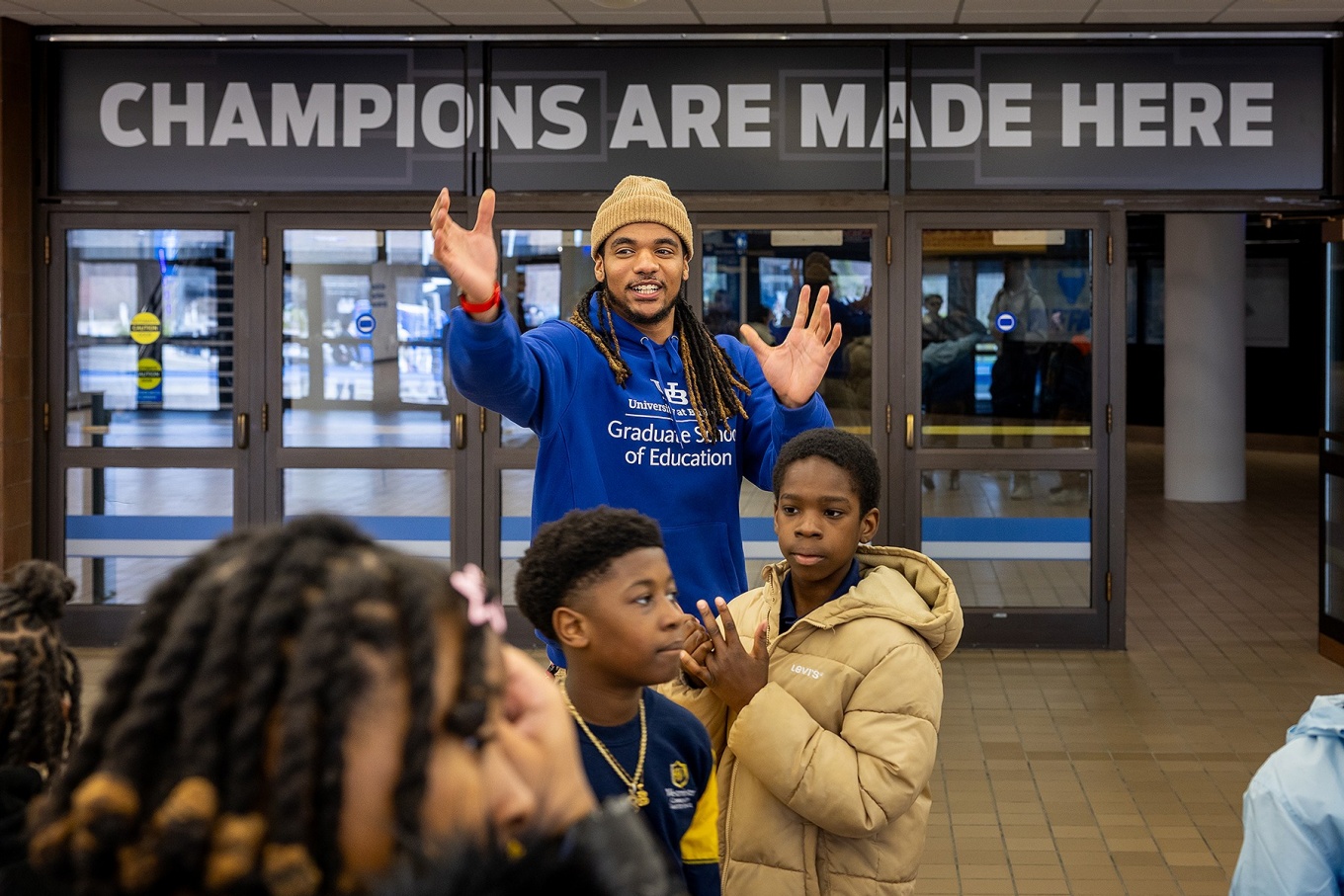 Taji Johnson speaks with school children about envisioning themselves at the University at Buffalo. 