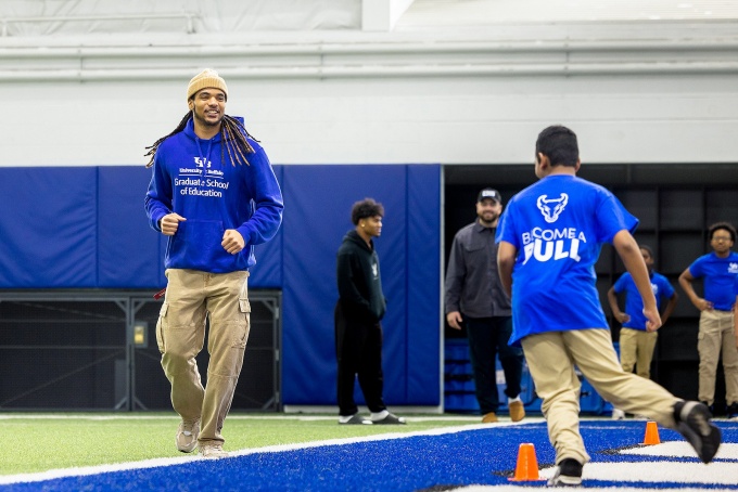 Taji Johnson plays a game with school children inside the Murchie Family field house. 
