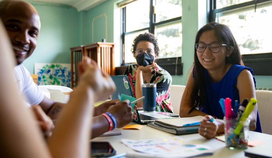 A group of people sit around a table. 