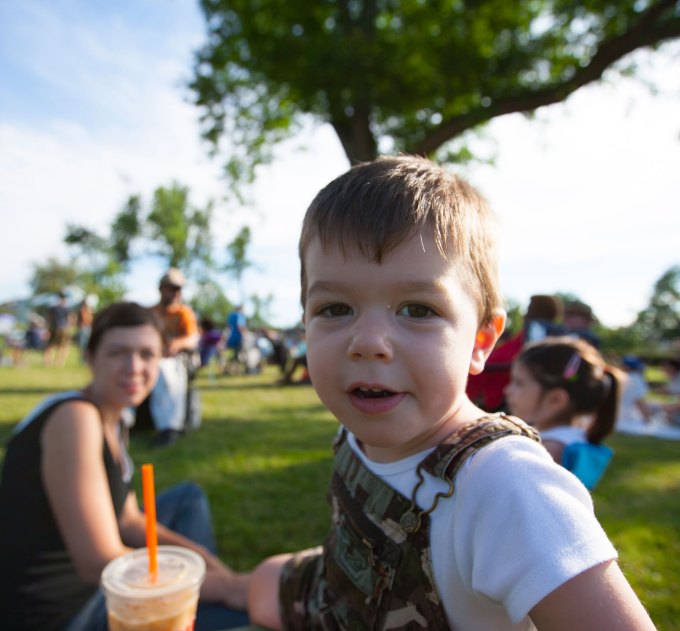 Family enjoying an outdoor UB on the Green performance. 