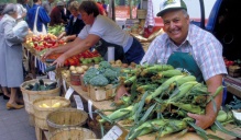 A farmer shows off his corn crop at the UB farmers market. 