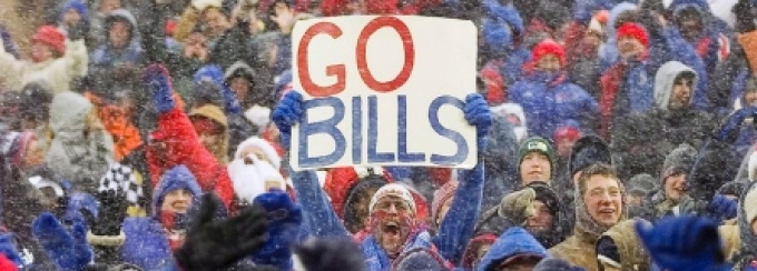 Excited fans at a Buffalo Bills game in the snow. 