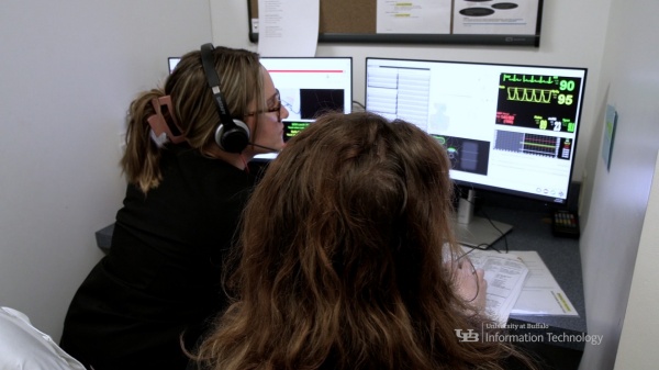 Zoom image: Graduate assistants in the DNP program running control room software at the UB School of Nursing. 